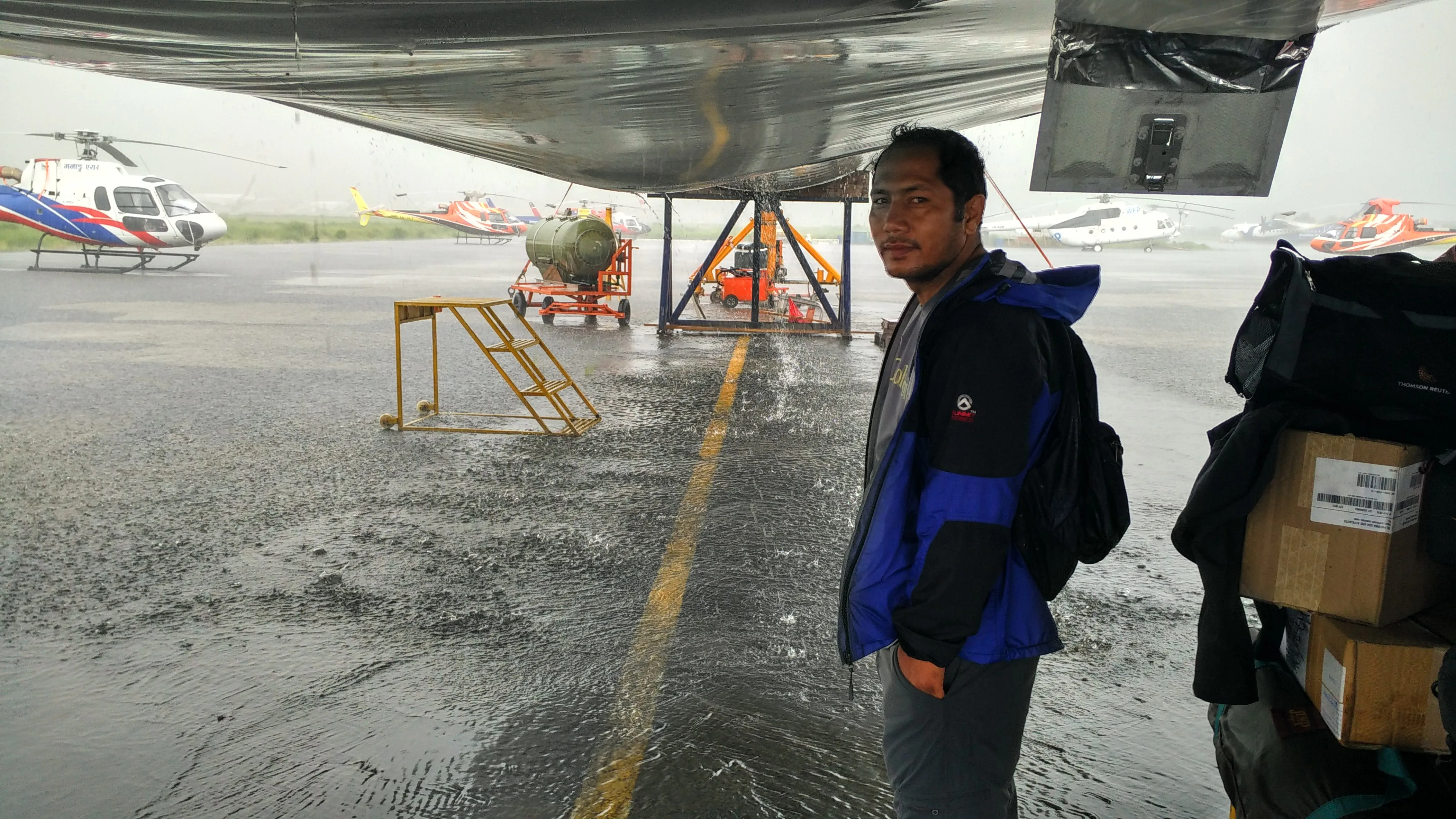 Gokul Thapa under the Turkish Airlines A330 to escape the heavy downpour.