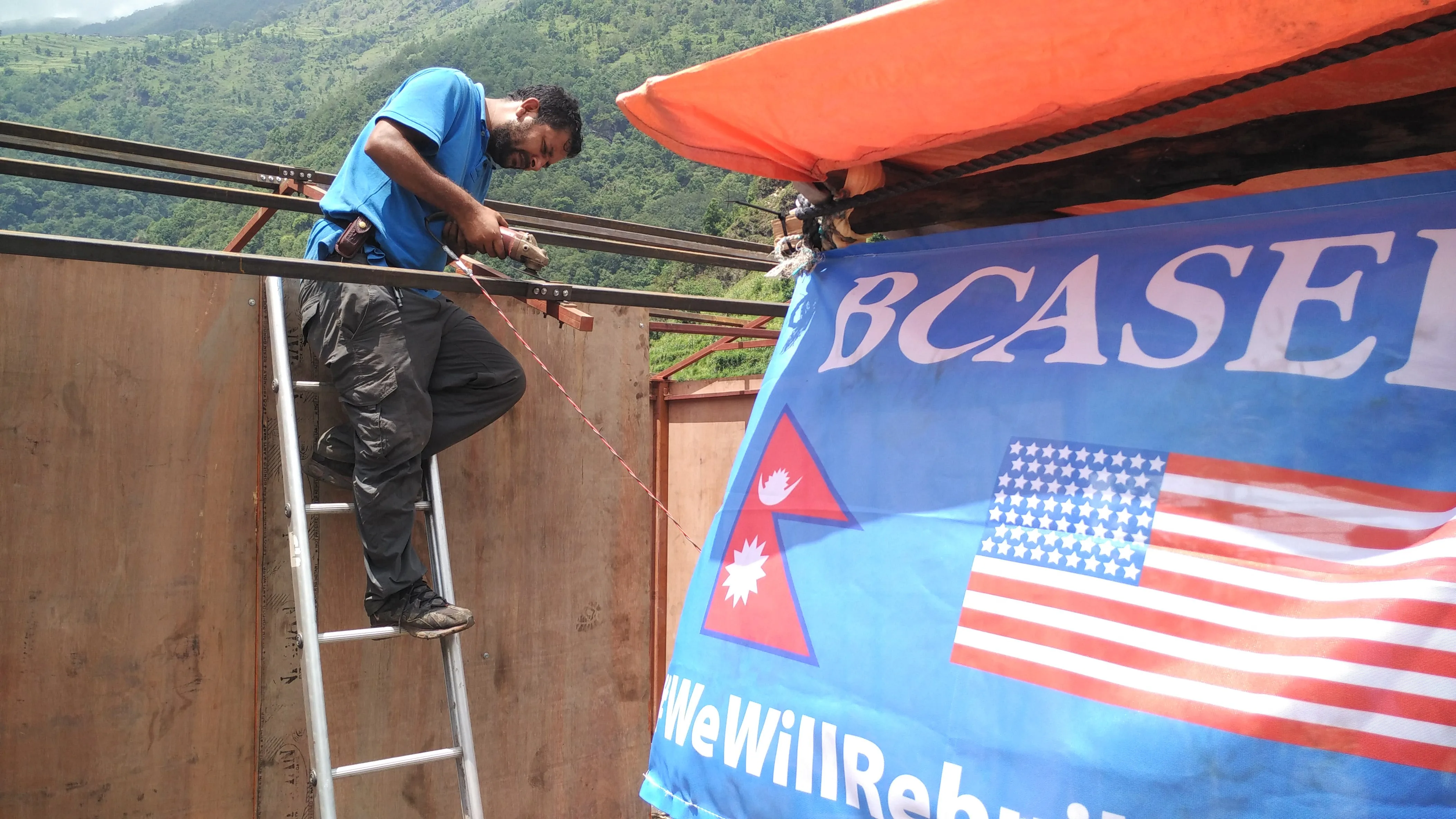 Prabin Khanal working away on building the house in Yangri.