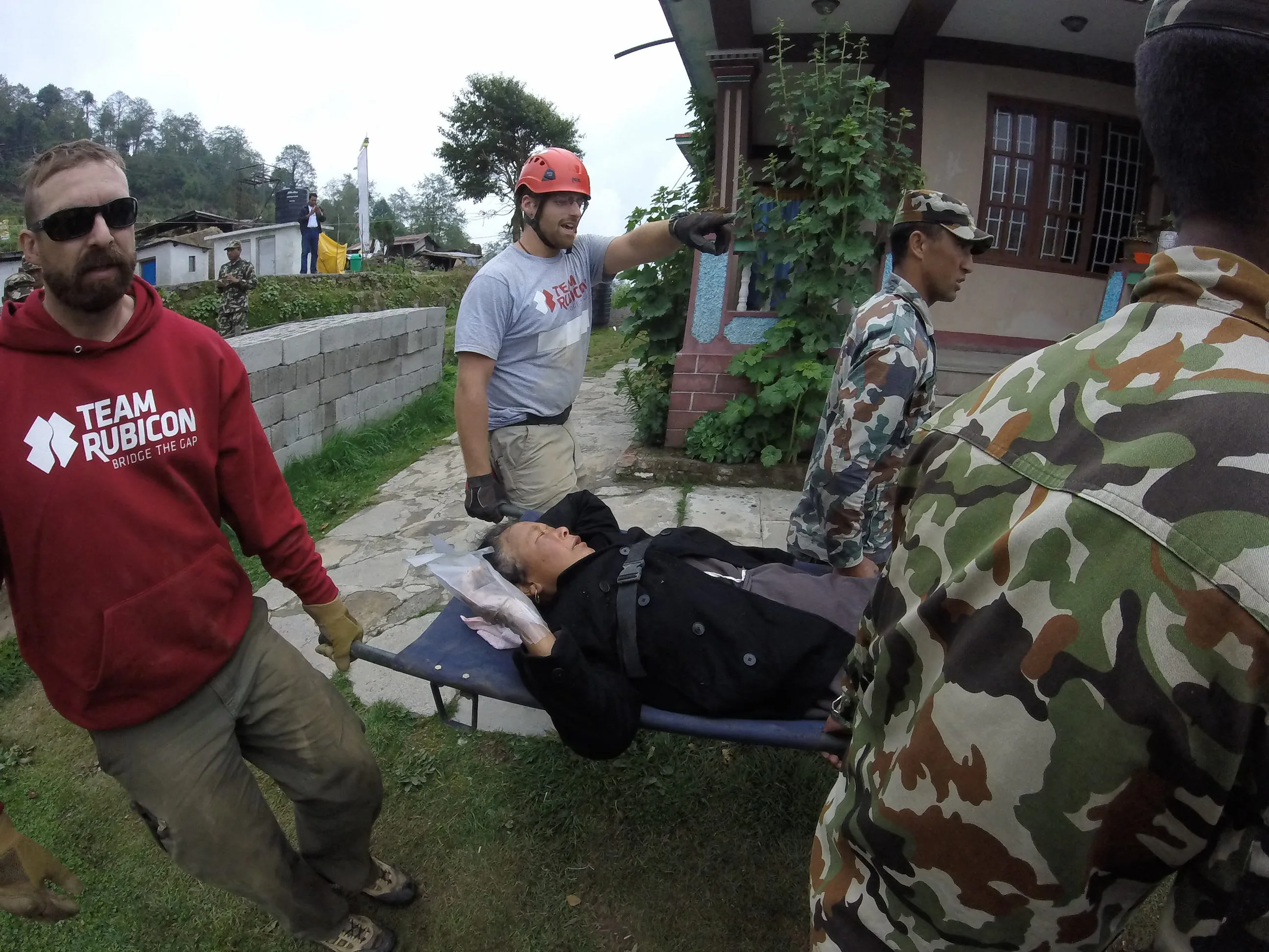 Team Rubicon in action in Shermathang. Moving patient to helipad for medevac.